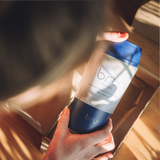 person holding bru ceramic travel mug 12oz in blue planet