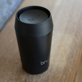 bru ceramic travel mug 8oz in black magic on wooden table
