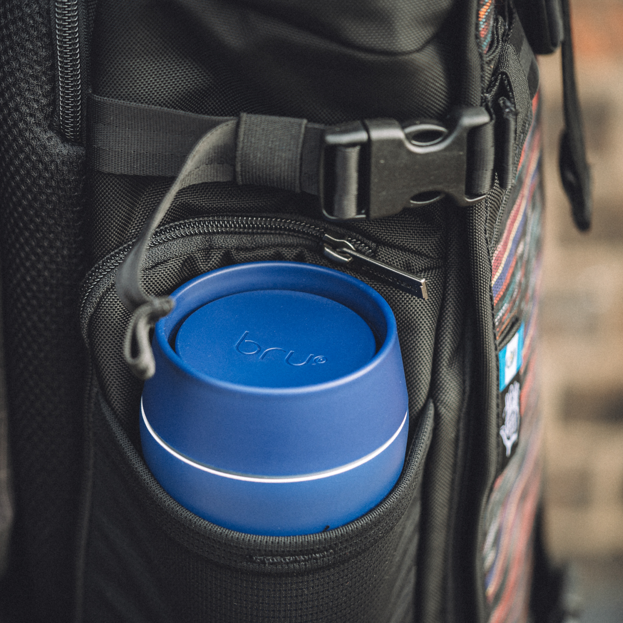bru ceramic travel mug in blue planet in backpack side pocket

