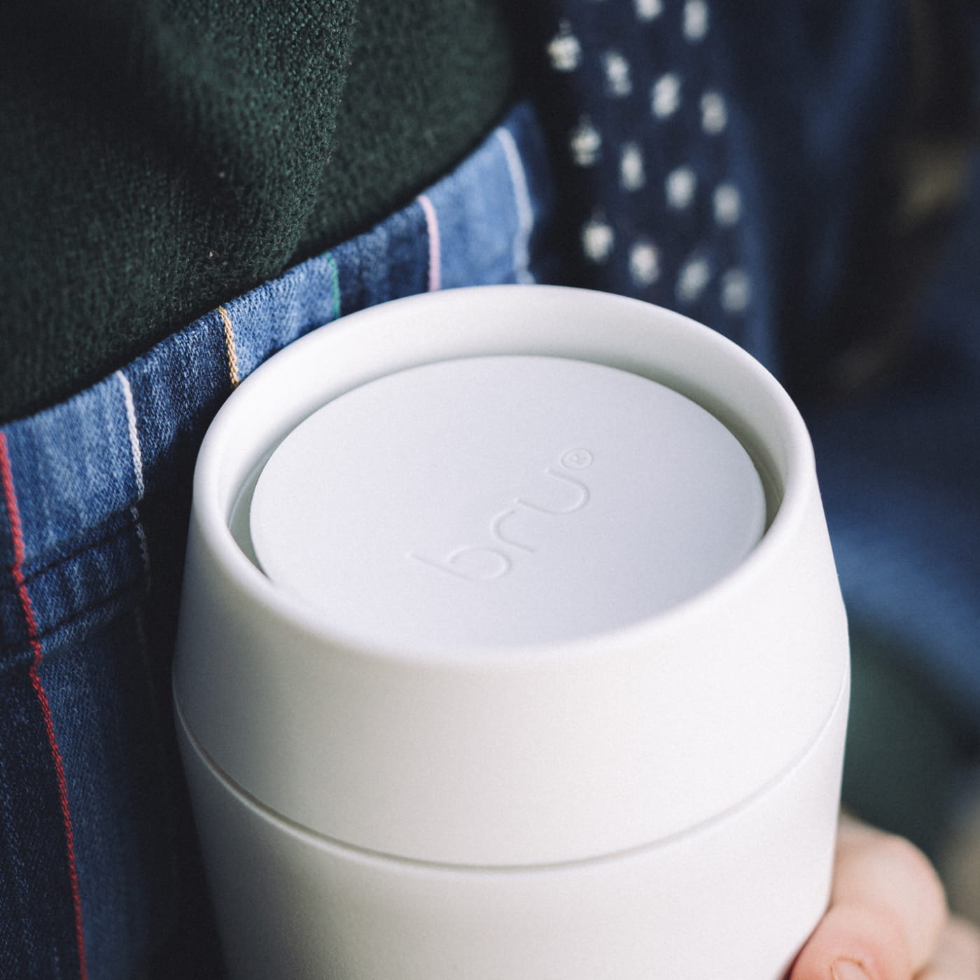 360 drinking lid block: Close-up of a white bru travel mug lid showing the 360 degree push-to-open drinking design